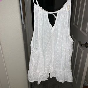 White tank top with floral patterns.